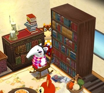 An Animal Crossing Pocket Camp: Complete screenshot of a corner of the cabin. Patty, a brown cow, is standing in the a small corner between two bookshelves. Annalise, a white anteater, is in a rocking chair in front of the shelves.