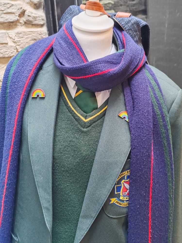Erin's school uniform from Derry Girls, including her rainbow pin badges and purple scarf