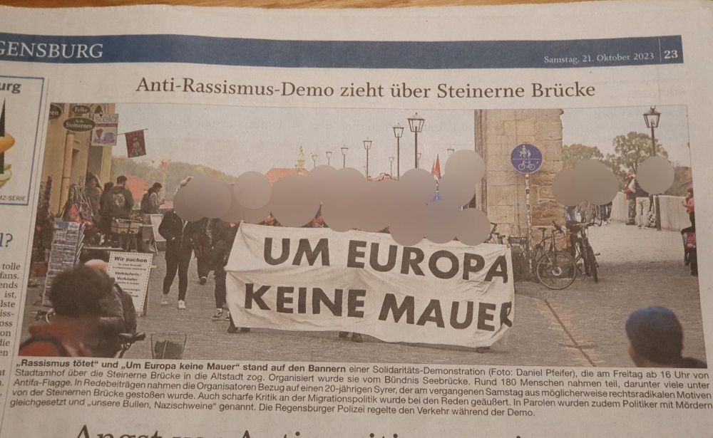 Bild einer Demonstration mit Transparent auf dem "um Europa keine mauer" steht.
