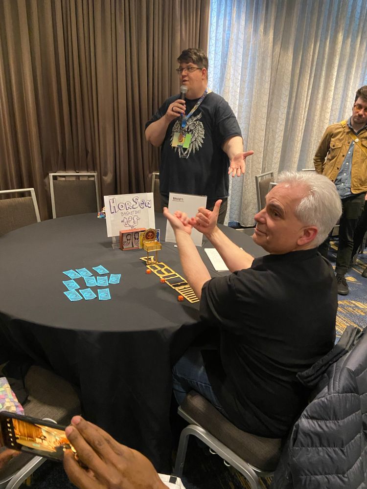 Curt demonstrating a tabletop dexterity game about playing HORSE during the ProAm game jam. 