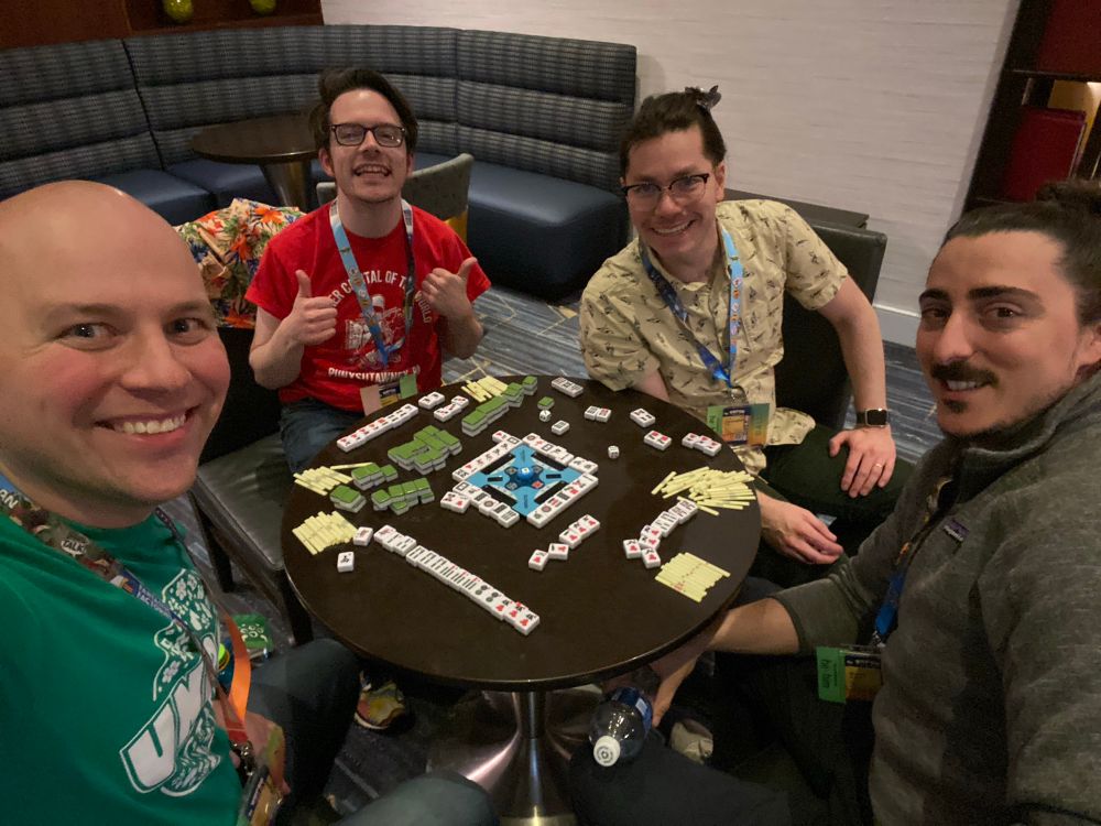 A selfie (probably shot around 2am) of Ian, Muzzy, Hunter, and me playing Riichi mahjong.