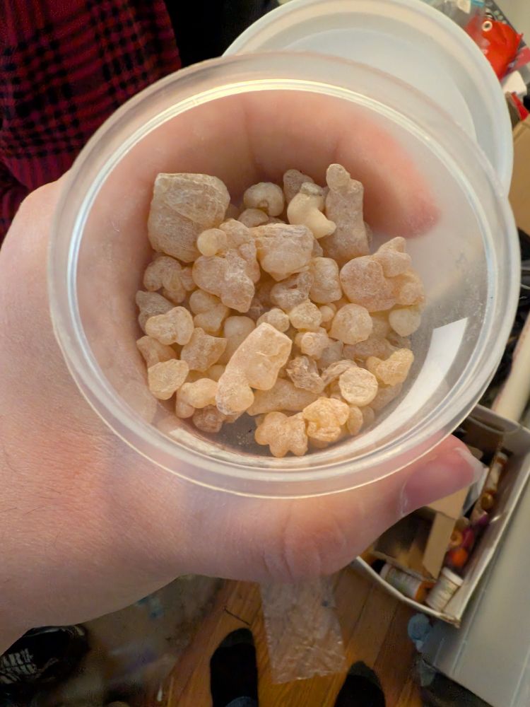 A small jar of frankincense, they are little off-white hunks of resin