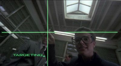 Robocop‘s targeting system depicted by a green cross off centre tracking a ball point pen held mid air OCP staff. 