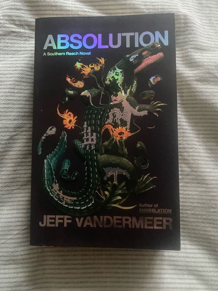 A book. Absolution by Jeff Vandermeer. Cover art depicts a speculative zoology.