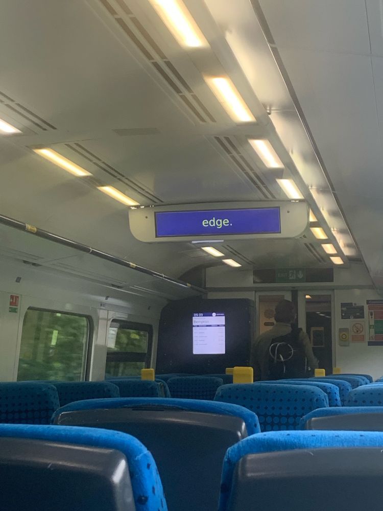 Image of my train’s announcement screen telling passengers to “mind the edge” but the text is cut off to simply tell users to “edge.”