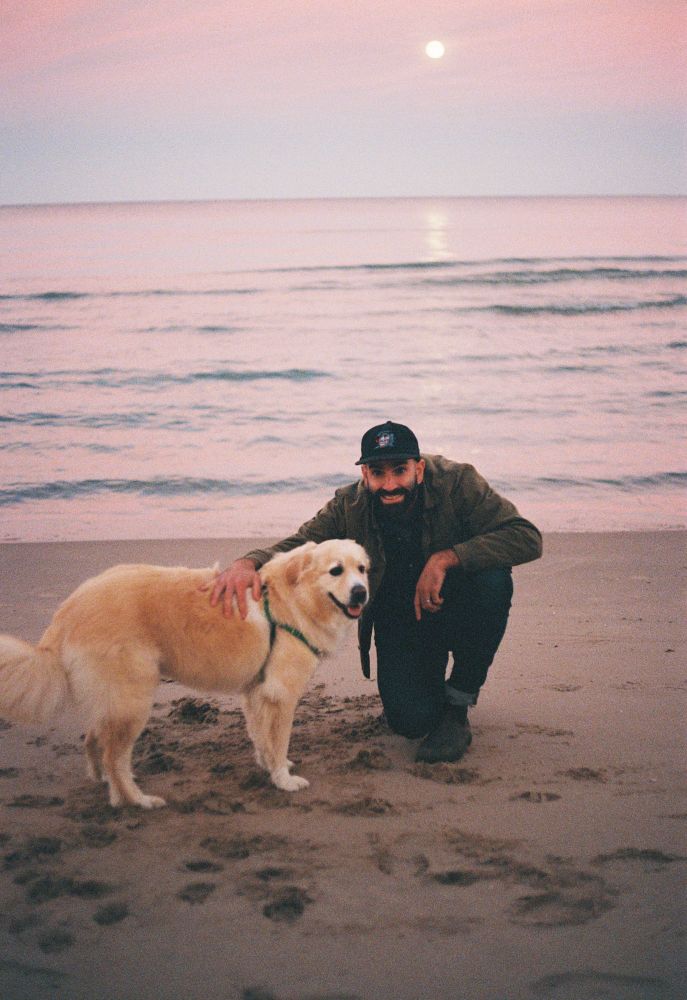 A man and a dog and Lake Michigan at twilight