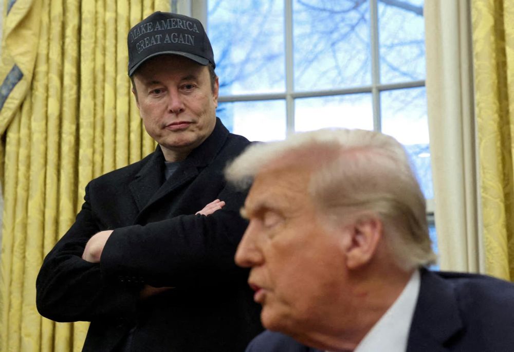 Elon Musk looks down at Trump  