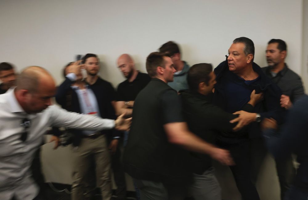 Image of Senator Alex Padilla being physically dragged away by the DHS secretary's security. 

