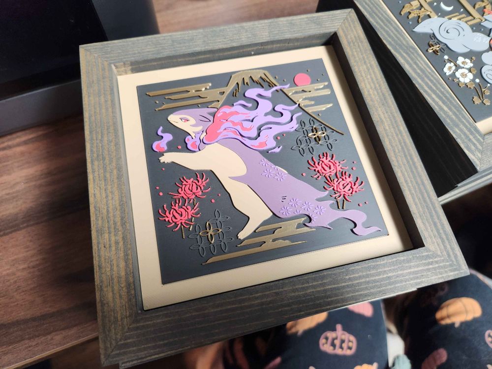 artwork of hisuian typhlosion inlayed in a square wooden frame.