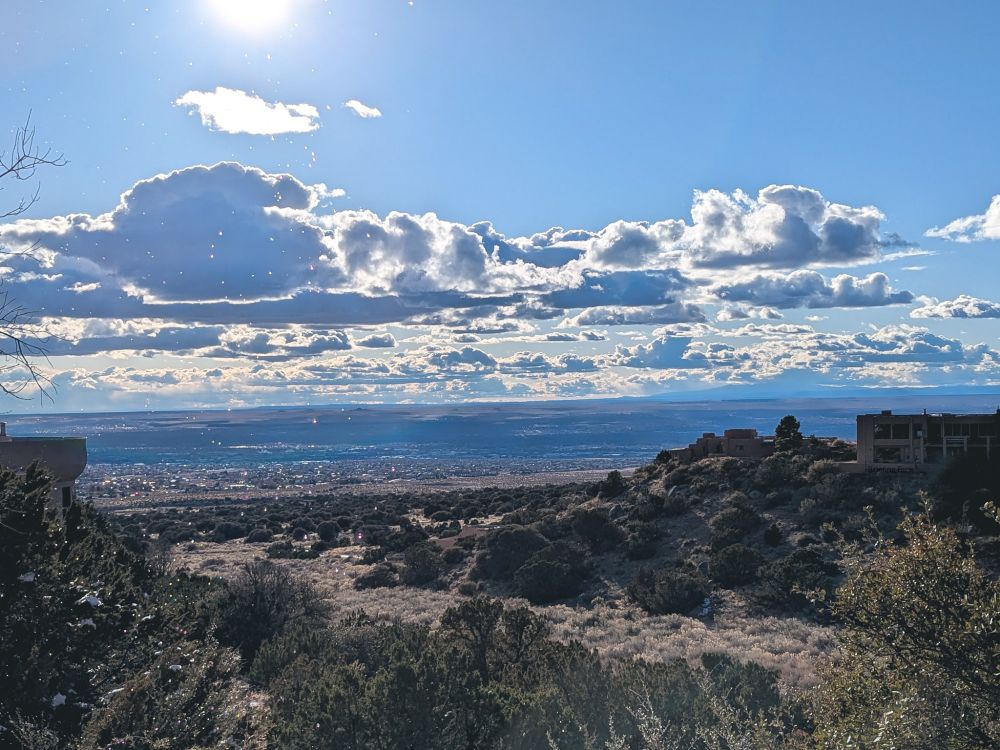 An excellent New Mexican sky, with rain falling in the foreground, and intensely sunlit clouds.