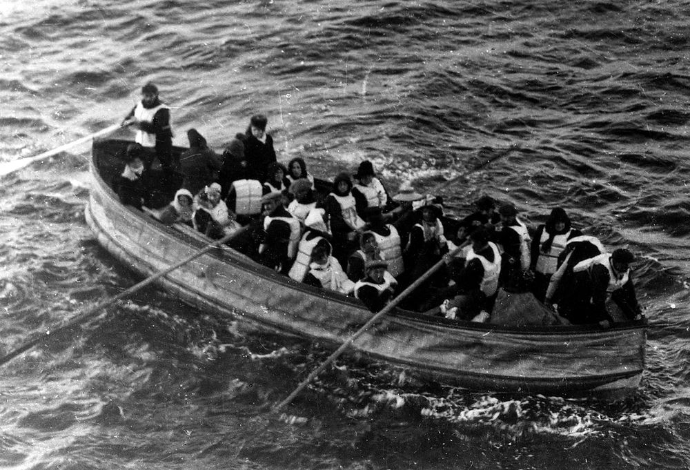 A photo of a lifeboat from the Titanic, with roughly 20 survivors, as it approaches the Carpathia rescue ship. One commonly used moral dilemma is to pick who lives and who dies in an overcrowded lifeboat that will sink unless some passengers are thrown overboard to lighten the load. Utilitarian morality proposes that a few should be sacrificed for the good of the many. Strict deontology would instead suggest that such killing is *always* wrong, even if it leads to further death. Credit: J.W. Barker (Carpathia passenger) in The Sphere (London, 4 May 1912).