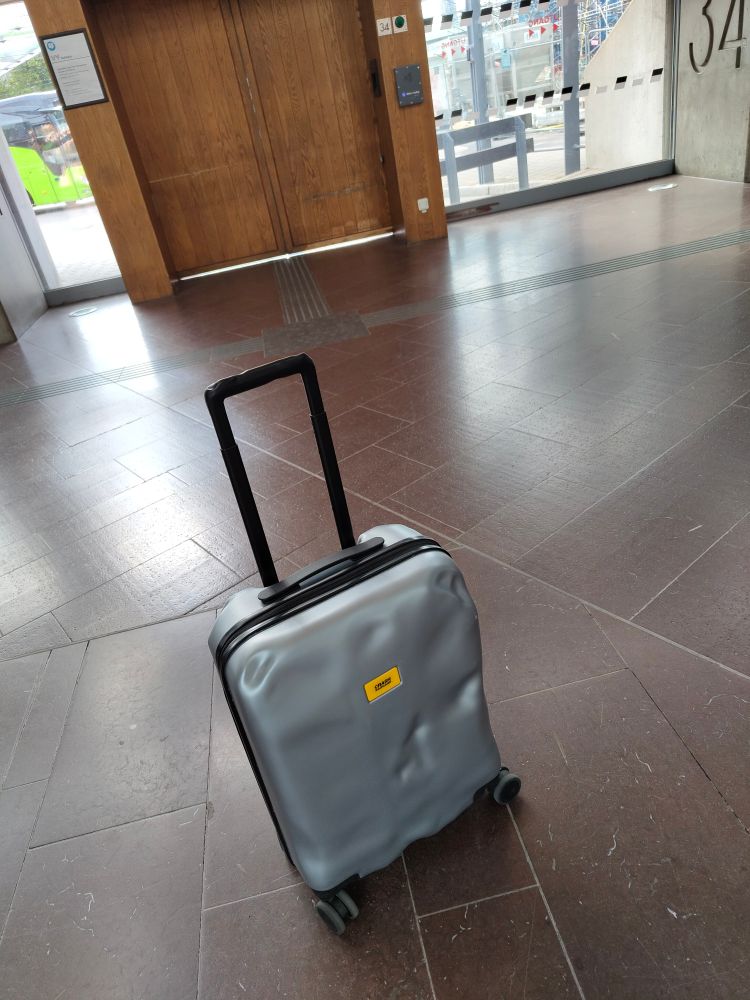 A packed suitcase waiting for the bus.