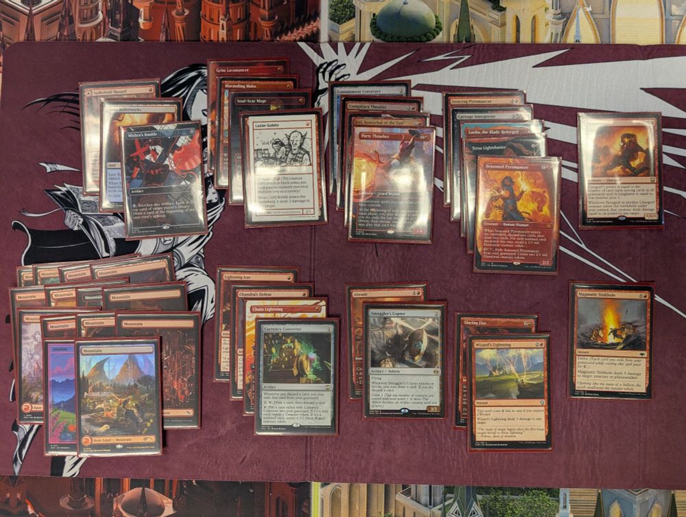 A draft deck from Sophie's mono red desert cube
Decklist
- Mountain x14
- Izzet Boilerworks
- Spikefield Hazard
- Mishras Bauble
- Grim Lavamancer
- Marauding Mako
- Soul-Scar Mage
- Lazier Goblin
- Lightning Axe
- Chandra's Defeat
- Chain Lightning
- Currency Converter
- Containment Construct
- Conspiracy Theorist
- Inti, Seneschal of the Sun
- Party Thrasher
- Abrade
- Smuggler's Copter
- Irencrag Pyromancer
- Carnage Interpreter
- Laelia, the Blade Reforged
- Seasoned Pyromancer 
- Slaying Fire
- Wizard's Lightning
- Pyrogoyf
- Magmatic Sinkhole