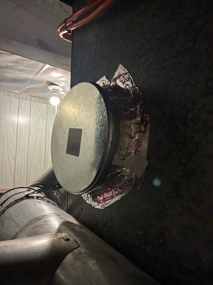 An HVAC cap installed on the side of an AC ducting with metallic tape sealing the edges. 