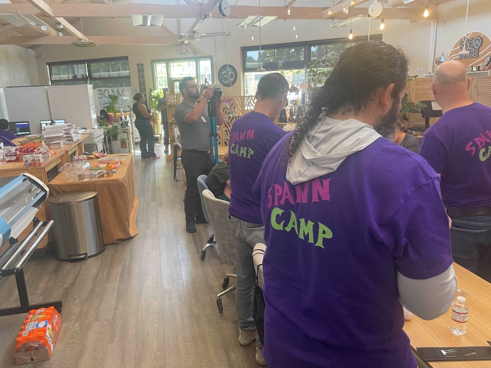 A row of volunteers standing next to a table