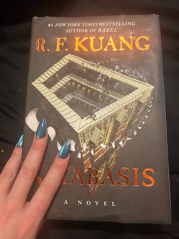 Hardcover copy of Katabasis by RF Kuang with my hand resting on it 