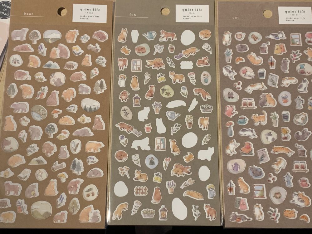 Three sheets of stickers of foxes, cats, bears and garden and house hold items.