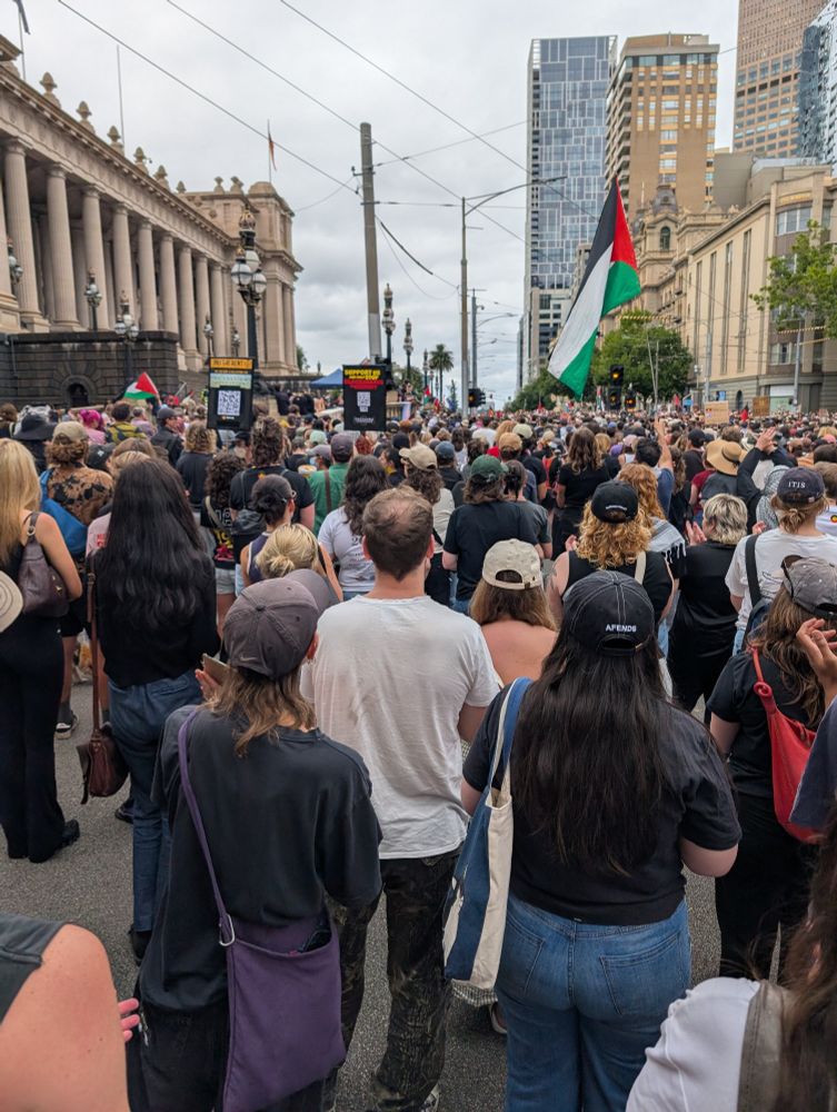 A crowd of people outside Parliament House