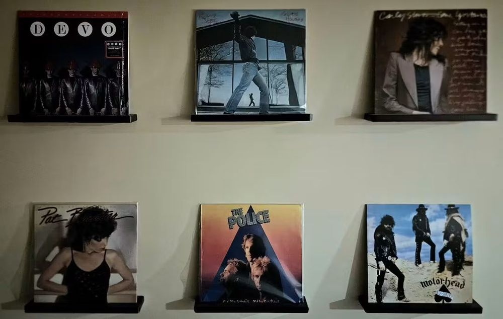 Vinyl records displayed in wall mounts. Albums Include:

Devo - Freedom of Choice
Billy Joel - Glass Houses
CarlySimon - Come Upstairs
Pat Benatar - Crimes of Passion
The Police - Zenyatta Mondatta
Motorhead - Ace of Spades