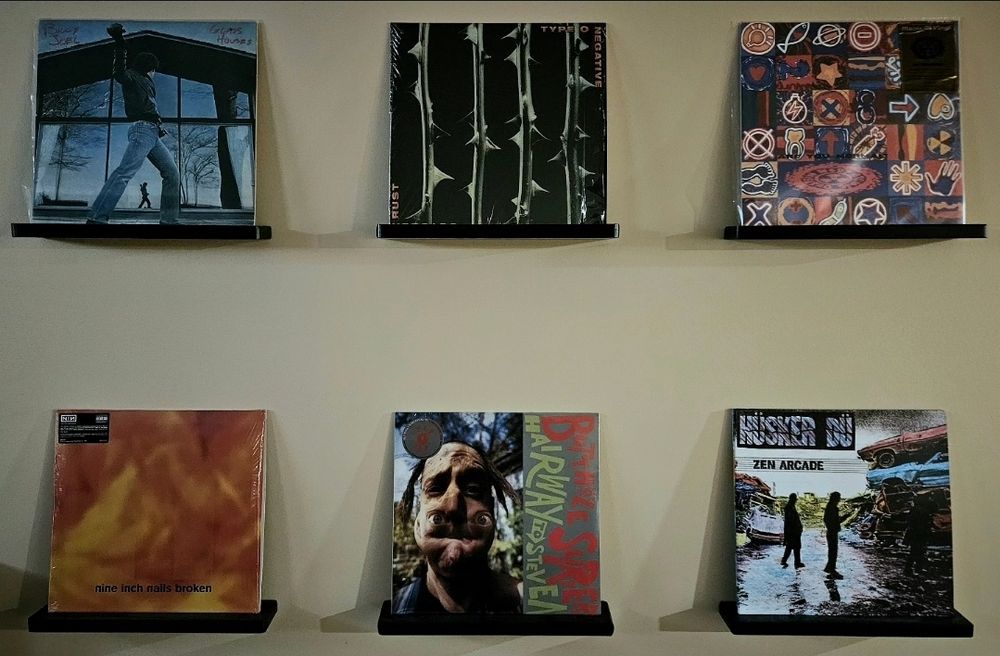 Vinyl records displayed in wall mounts. Albums include:

Billy Joel - Glass Houses
Type O Negative - October Rust
Neds Atomic Dustbin - Are You Normal?
Nine Inch Nails - Broken
Butthole Surfers - Hairway to Steven
Husker Du - Zen Arcade