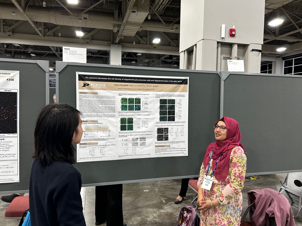 Labony presenting her research poster on optic nerve demyelination. 