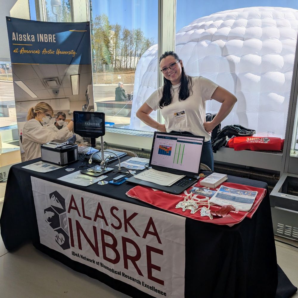 Woman standing at a display table with sequencing demonstration