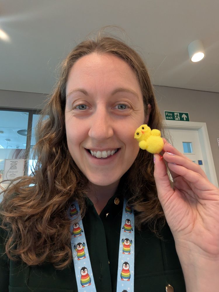 Mw holding a yellow fluffy chick toy with yellow glasses up to my face