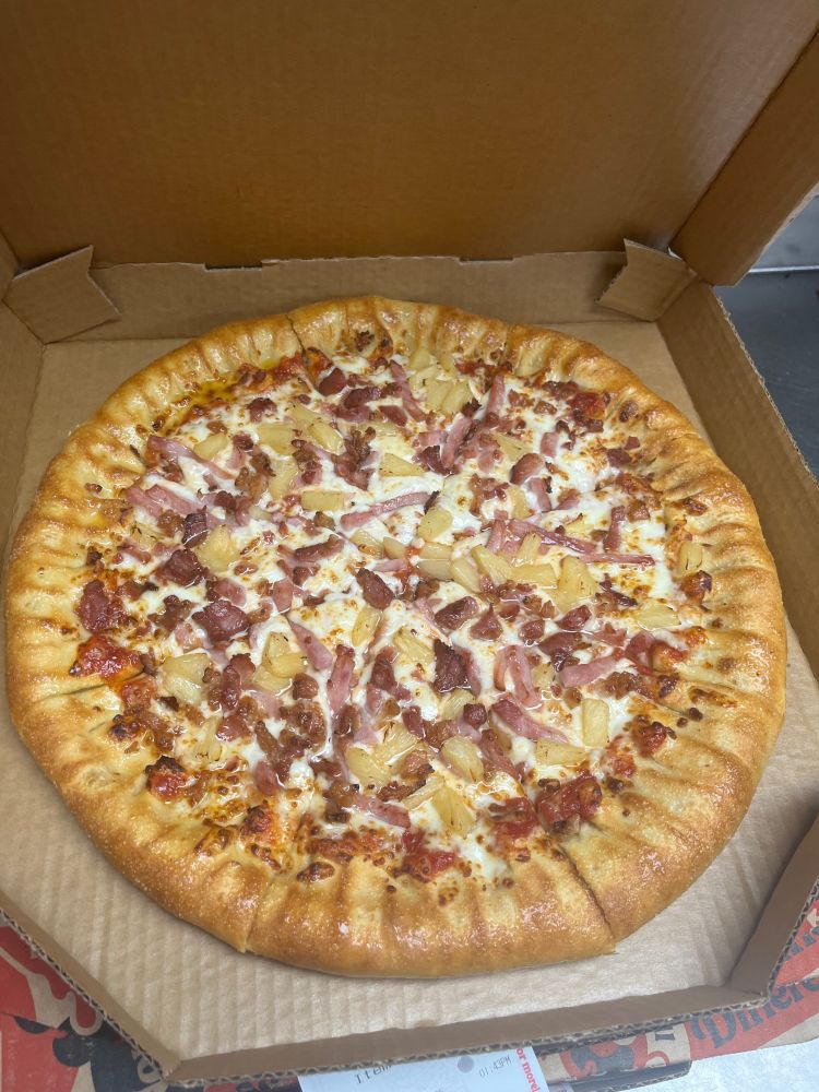 a stuffed crust Hawaiian pizza. it has bacon, ham, and pineapple as toppings.