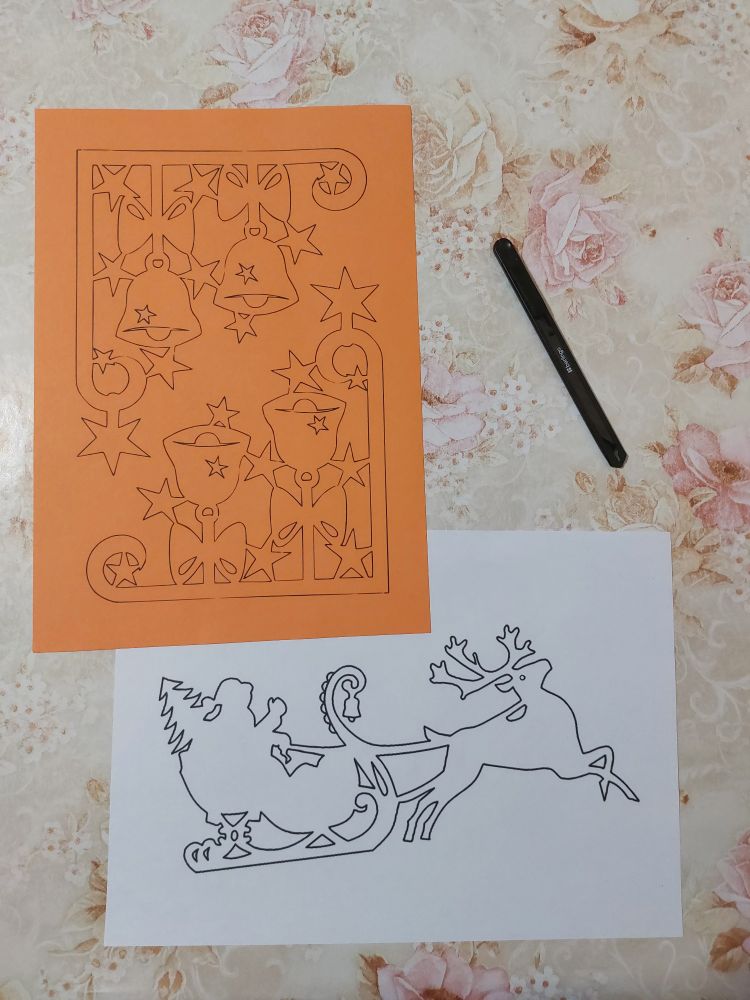 A selection of 2 printed illustrations, featuring bells to be stuck on the corners of the window, and Father Frost with Deer.