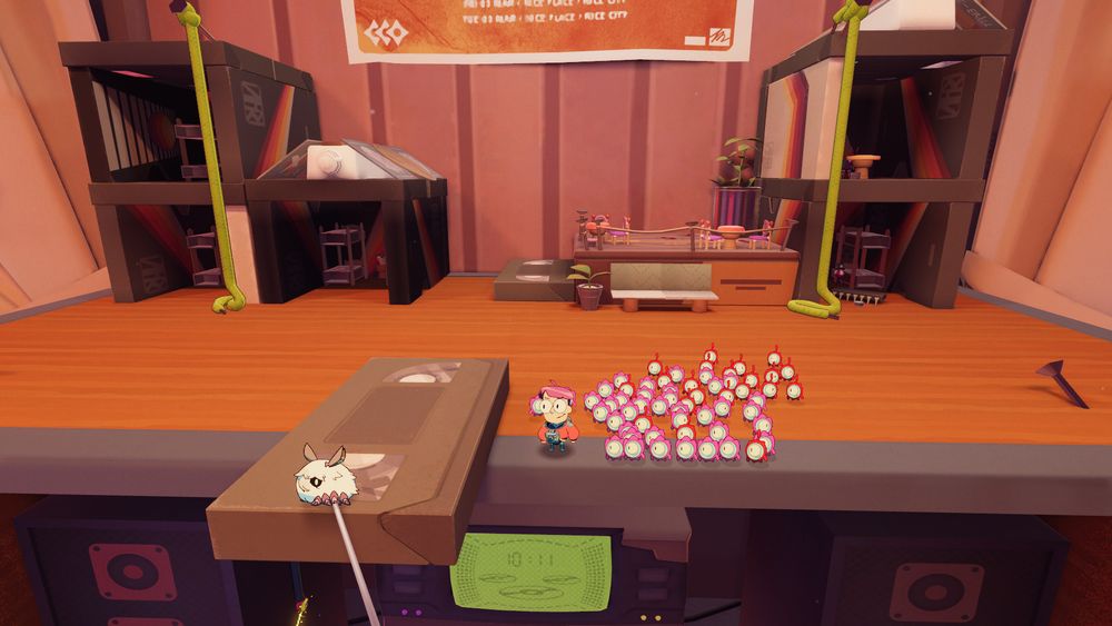 Screenshot from "Tinykin". Here, Milo just chills with tinykin creatures on top of an audio gear shelf.