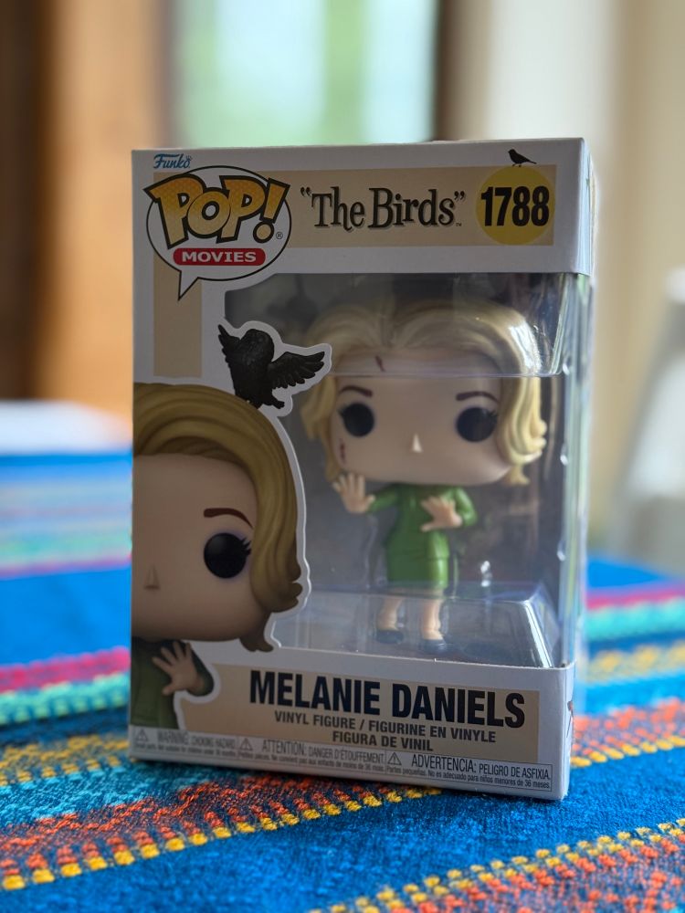 Funko pop or Melanie from Hitchcock’s The Birds. 