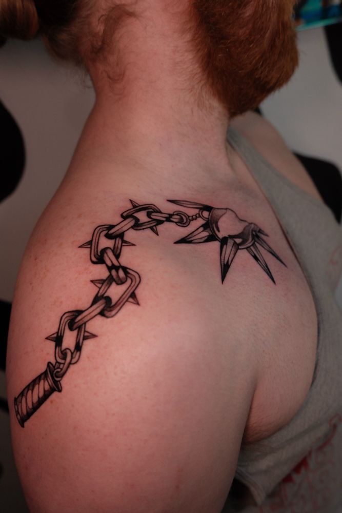 Heart flail top view. Heart on collarbone, chains draping over the shoulder, handle on the back