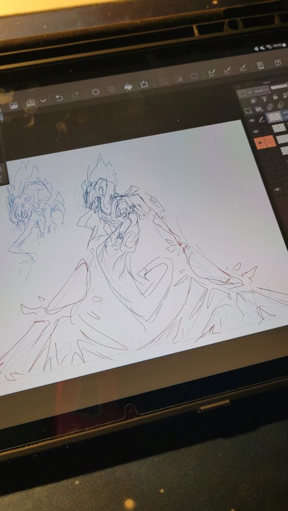 Photo of a tablet open to a digital art program. The program displays a rough sketch of a dragon with unique floating wings that are emerging from the ground. 