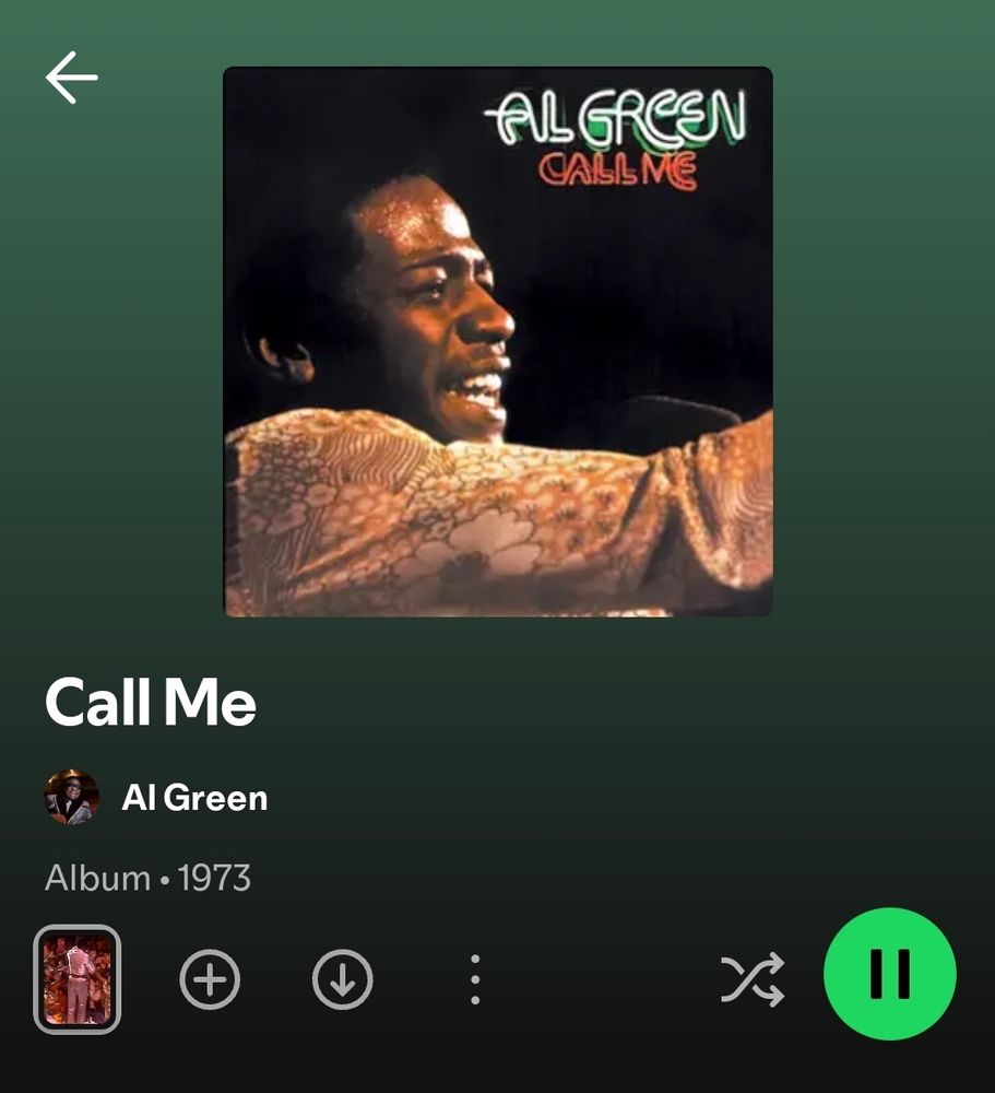 Album cover for Al Green's album Call Me featuring an image of Al Green singing into a microphone with his arm raised. He's wearing a shirt covered in flowers 