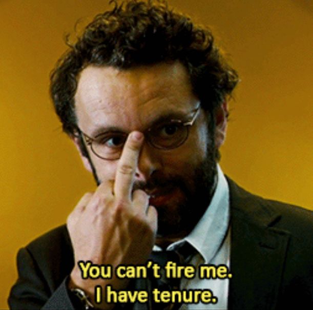Michael Sheen in Jesus Henry Christ. He is wearing a suit and glasses, pushing up the glasses with his middle finger 🖕🏼 after saying “you can’t fire me. I have tenure.”