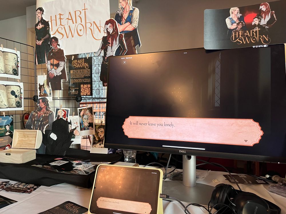 Indie game booth featuring lots of artwork from Heart Sworn at Brilliant Indie Treasures in Brighton, UK.