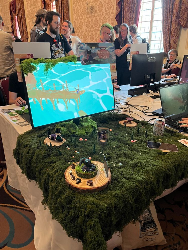 Indie game booth with moss and figurines at Brilliant Indie Treasures in Brighton, UK.