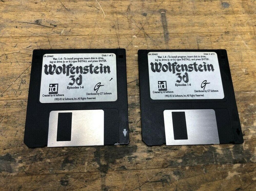 Two floppy disks with the DOS game Wolfenstein 3D.