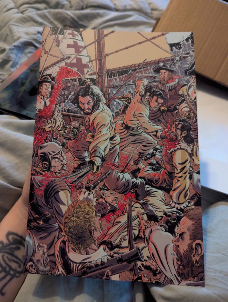 Picture of hand holding physical copy of Kraig Rasmussen cover of BRZRKR Bleeding Tide