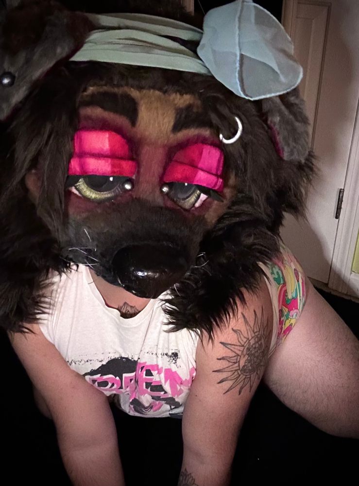 Bailey is leaning more forward looking more to the right- she is wearing a Green Day shirt from the uno dos tres era and some psychedelic patterned panties