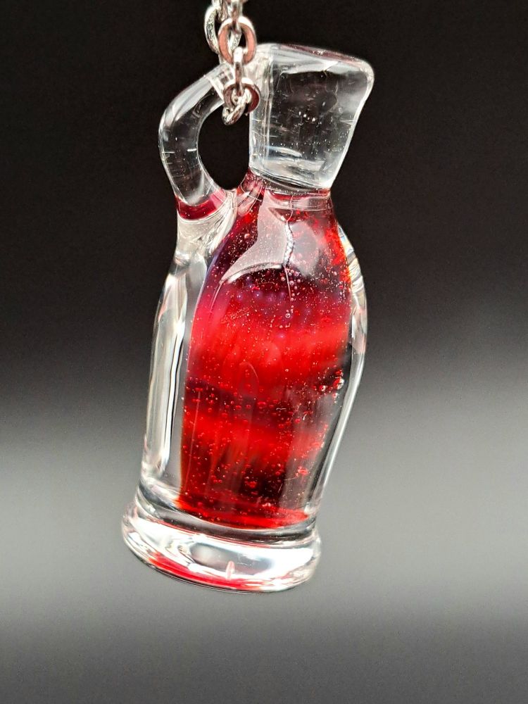 A picture of a hanging glass potion bottle. This potion is a clear bottle with a bubbling red potion on the inside. What are the effects? 