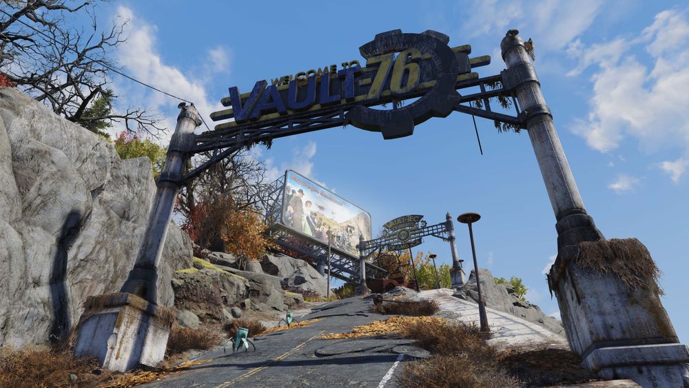 A screenshot in Fallout 76 of the Vault 76 arch sign. A road leads up a hill with various Vault 76 signs and billboards