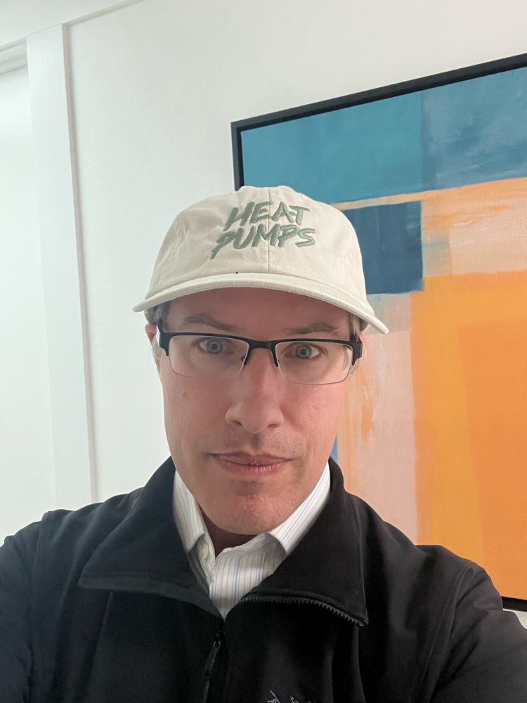 KC Boyce wearing a hat that says “heat pumps”