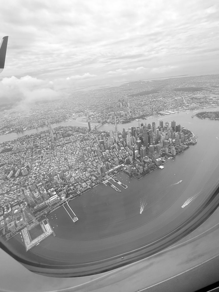 Black and white photo of downtown Manhattan taken from an airplane window