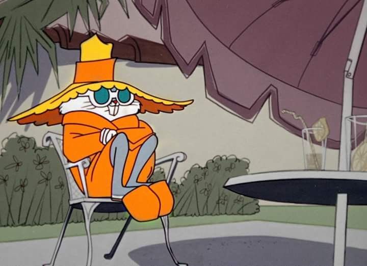 Bugs Bunny hunkered under a patio umbrella, in sunhat and sunglasses.