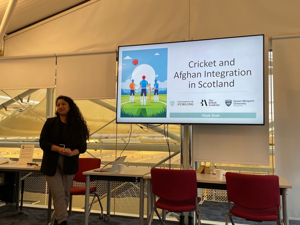 Hijab Shah stood next to her introductory PowerPoint slide. The title is: Cricket and Afghan Integration in Scotland.