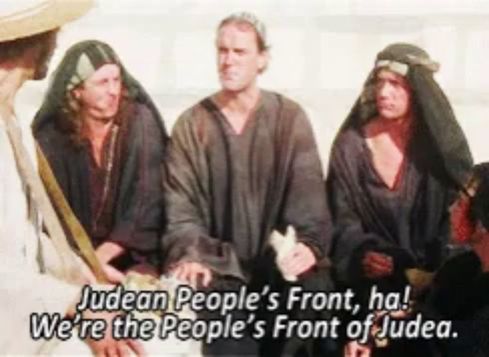 a group of men are sitting in front of a sign that says judean people 's front