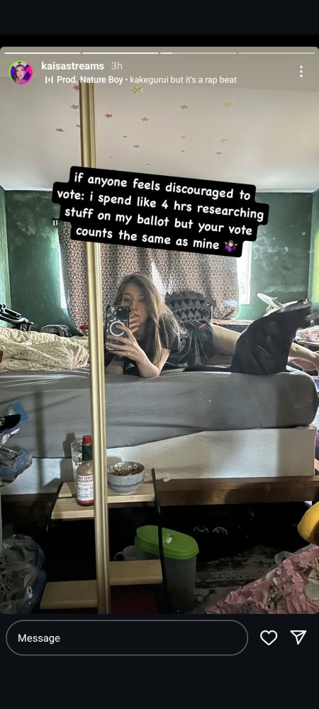 A screenshot of an e-girl's Instagram story, her sprawling on a bed in a messy room, presumably hers, a selfie shot at a mirror, with a caption reading 