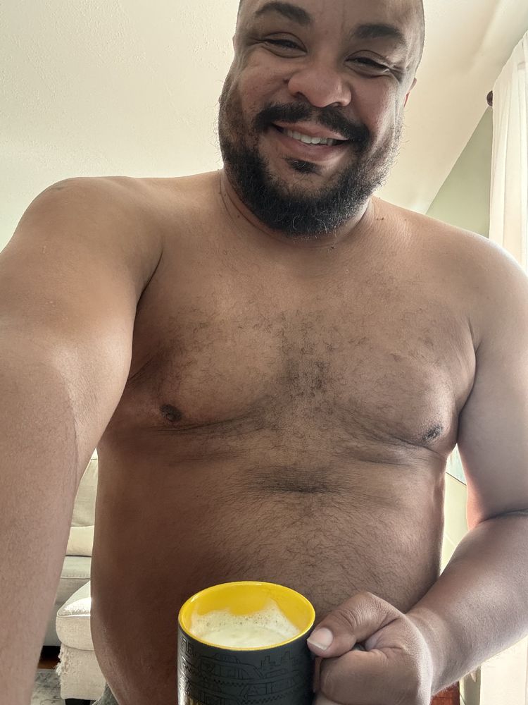 Selfie of me, shirtless, holding a caffeinated beverage