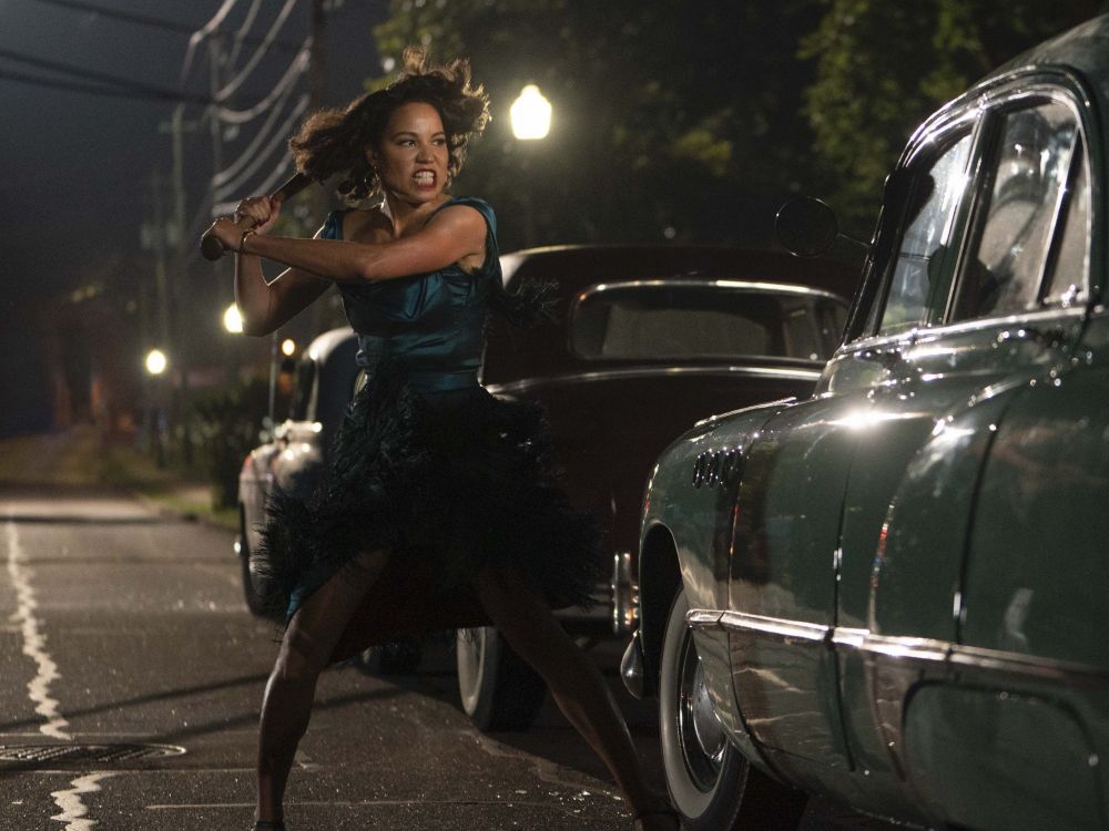 Jurnee Smollett swing a bat towards a car window in the tv series 'Lovecraft Country'
